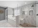 Modern bathroom with glass shower, soaking tub, and decorative tile wall at 7307 S Trask St, Tampa, FL 33616