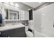 Traditional bathroom with a white shower-tub combination, modern vanity with a bright white countertop at 7307 S Trask St, Tampa, FL 33616