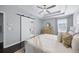 Bright bedroom with a sliding barn door entry to the bathroom and modern ceiling fan at 7307 S Trask St, Tampa, FL 33616