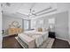 Spacious bedroom features a tray ceiling, ceiling fan, and white patterned rug at 7307 S Trask St, Tampa, FL 33616