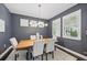 Elegant dining room with stylish light fixture, plantation shutters, seating for six, and neutral decor at 7307 S Trask St, Tampa, FL 33616