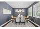 Elegant dining room with stylish light fixture, plantation shutters, seating for six, and neutral decor at 7307 S Trask St, Tampa, FL 33616