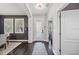 Inviting foyer with dark wood floors, decorative rug, elegant lighting, and views into the dining room at 7307 S Trask St, Tampa, FL 33616