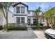 Charming two-story home with manicured landscaping and a welcoming front porch, and attractive black and white design at 7307 S Trask St, Tampa, FL 33616