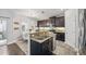 Kitchen features granite countertops, stainless steel appliances, breakfast bar and dark cabinets providing a modern cooking space at 7307 S Trask St, Tampa, FL 33616