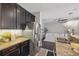 Open concept kitchen features granite counters, stainless steel appliances, a breakfast bar, and seamless flow to the living area at 7307 S Trask St, Tampa, FL 33616