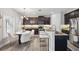 Modern kitchen features granite countertops, dark cabinets, stainless steel appliances, breakfast bar, and cozy eat-in area at 7307 S Trask St, Tampa, FL 33616