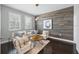 Comfortable living room with decorative wood wall, neutral furniture, stylish lighting, and lots of natural light at 7307 S Trask St, Tampa, FL 33616