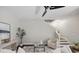 Bright living room featuring neutral tones, modern furniture, and adjacent staircase, offering a cozy and inviting space at 7307 S Trask St, Tampa, FL 33616