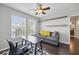 Bright home office featuring a desk, sofa, cityscape art, and natural light, offering a versatile workspace or study area at 7307 S Trask St, Tampa, FL 33616