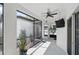 Enclosed patio with ceiling fan, tile flooring, and views of the green backyard at 7307 S Trask St, Tampa, FL 33616