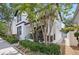 Side view of a well-maintained home with lush greenery, a manicured garden, and a charming walkway at 7307 S Trask St, Tampa, FL 33616