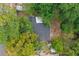 Aerial view of a home with a new roof surrounded by lush green trees at 8704 N Brooks St, Tampa, FL 33604