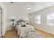 Cozy bedroom featuring a plush bed, soft lighting, and two windows for ample natural light at 8704 N Brooks St, Tampa, FL 33604