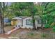 Charming home with a freshly landscaped yard, walkway, and a black and white color scheme at 8704 N Brooks St, Tampa, FL 33604