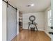 Entryway featuring shiplap wall, modern decor, sliding barn door, and wood-look floors at 8704 N Brooks St, Tampa, FL 33604