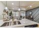 Modern kitchen with stainless steel sink, stone countertops, stainless appliances, and stylish pendant lights at 8704 N Brooks St, Tampa, FL 33604