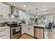 Beautiful kitchen featuring stainless steel appliances, white cabinets, subway tile backsplash, and bright lighting at 8704 N Brooks St, Tampa, FL 33604