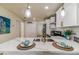 Gourmet kitchen island features stainless steel sink, stylish faucet, and modern pendant lighting at 8704 N Brooks St, Tampa, FL 33604