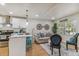 Sunlit living room with open layout, kitchen bar seating, and modern decor at 8704 N Brooks St, Tampa, FL 33604