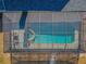 Aerial view of screened pool and spa, offering a private backyard oasis at 8755 Ogleby Creek Rd, Myakka City, FL 34251