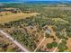 Expansive aerial view showcasing multiple homes nestled among lush greenery and wooded areas at 8755 Ogleby Creek Rd, Myakka City, FL 34251