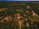 Stunning aerial view of a rural property with a home, surrounded by lush greenery and trees at 8755 Ogleby Creek Rd, Myakka City, FL 34251