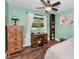 Cozy bedroom featuring a wooden desk, bookshelf, and a ceiling fan at 8755 Ogleby Creek Rd, Myakka City, FL 34251
