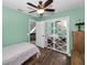 Bedroom featuring light green walls and a closet with decorative sliding doors at 8755 Ogleby Creek Rd, Myakka City, FL 34251