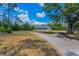 Beautiful one-story home with a spacious wraparound porch and a peaceful, sprawling lawn at 8755 Ogleby Creek Rd, Myakka City, FL 34251