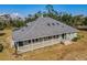 Charming single-story home with a spacious wraparound porch and a well-maintained yard at 8755 Ogleby Creek Rd, Myakka City, FL 34251