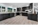 Contemporary kitchen with stainless appliances, dark cabinets, tile flooring, and ample counter space at 8755 Ogleby Creek Rd, Myakka City, FL 34251