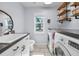 Efficient laundry room equipped with modern appliances, ample storage, and a practical layout at 8755 Ogleby Creek Rd, Myakka City, FL 34251