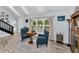 Inviting living room features vaulted ceilings, natural light, and comfortable seating near a window at 8755 Ogleby Creek Rd, Myakka City, FL 34251
