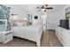 Bright main bedroom featuring a ceiling fan, wood floors, and ensuite bath at 8755 Ogleby Creek Rd, Myakka City, FL 34251