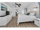 Serene main bedroom with hardwood floors, soft lighting, and a comfortable layout for relaxation at 8755 Ogleby Creek Rd, Myakka City, FL 34251