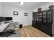 Office with wood floors, white walls, built-in shelves, and desk with office chair at 8755 Ogleby Creek Rd, Myakka City, FL 34251
