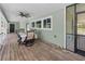 Spacious covered porch featuring dining set and backyard views at 8755 Ogleby Creek Rd, Myakka City, FL 34251