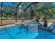 Inviting pool and spa area, surrounded by lush landscaping and comfortable lounge chairs at 8755 Ogleby Creek Rd, Myakka City, FL 34251