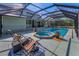 Beautiful backyard oasis featuring a screened pool, spa, and patio at 8755 Ogleby Creek Rd, Myakka City, FL 34251