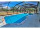 Large screened in pool area with attached spa, perfect for outdoor relaxation and entertainment at 8755 Ogleby Creek Rd, Myakka City, FL 34251