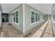 Expansive wraparound porch with ample space and natural light, perfect for outdoor living at 8755 Ogleby Creek Rd, Myakka City, FL 34251