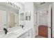 Bright bathroom features dual sinks, modern fixtures, and a large mirror enhancing the space at 9422 Clover Glen Dr, Riverview, FL 33569