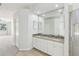 Bright bathroom featuring double sinks, granite countertops, and a glass-enclosed shower at 9422 Clover Glen Dr, Riverview, FL 33569
