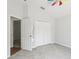 Bright bedroom boasts ceiling fan and access to hall with reflected mirror at 9422 Clover Glen Dr, Riverview, FL 33569