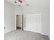 Cozy bedroom with large closet and access to hallway with mirrored door at 9422 Clover Glen Dr, Riverview, FL 33569