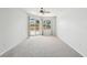 Bright bedroom with neutral carpets, large window, and sliding glass door to the patio at 9422 Clover Glen Dr, Riverview, FL 33569
