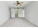 Spacious bedroom featuring neutral carpets, a ceiling fan and an ensuite bathroom at 9422 Clover Glen Dr, Riverview, FL 33569