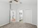 Neutral bedroom with carpet and ceiling fan, connects to bathroom and closet at 9422 Clover Glen Dr, Riverview, FL 33569