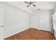 Bedroom with wood flooring, a ceiling fan and two double closets at 9422 Clover Glen Dr, Riverview, FL 33569